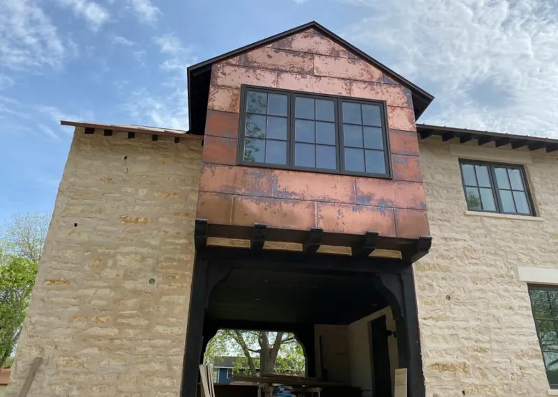 Copper metal panel facade on a stone building for Metal Roof Coating in Charter Oak
